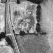 Oblique aerial view centred on the cropmarks of an enclosure and unenclosed settlement.