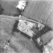 Oblique aerial view centred on the cropmarks of an enclosure and unenclosed settlement.