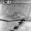 Oblique aerial view centred on the indeterminate cropmarks and tracks, taken from the NNW.