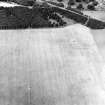 Oblique aerial view centred on the cropmarks of the Roman temporary fort, taken from the SE.