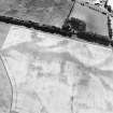 Oblique aerial view centred on the cropmarks of the round barrows, square barrows, enclosure, roundhouse, pits, field boundary, pit-alignment and rig, taken from the NNW.