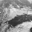 Oblique aerial view centred on the remains of the township and rig with the remains of the township adjacent, taken from the NNE.