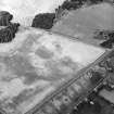 Oblique aerial view centred on the cropmarks of the unenclosed settlement, taken from the SE.