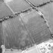 Oblique aerial view centred on the cropmarks of pits, a roundhouse, possible enclosure and rig, taken from the ESE.