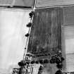 Oblique aerial view centred on the cropmarks of the ring-ditch, taken from the WSW.