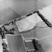 Oblique aerial view centred on the cropmarks of the trackway with the remains of the farmstead adjacent, taken from the SW.