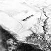 Oblique aerial view of Balhall centred on the remains of small cairns and a possible enclosure with a field-system and cairns adjacent, taken from the E.