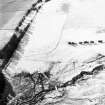 Oblique aerial view of Balhall centred on the remains of small cairns and a possible enclosure, taken from the NE.