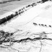 Oblique aerial view of Balhall centred on the remains of small cairns and a possible enclosure, taken from the NNE.