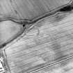 Oblique aerial view centred on the cropmarks of the enclosure, pits, rig and field boundary, taken from the SSE.
