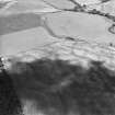 Oblique aerial view centred on the cropmarks of an unenclosed settlement, pit-defined enclosure and souterrains, taken from the S.