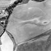 Oblique aerial view centred on the cropmarks of the barrows, ring-ditches and square barrows, taken from the W.