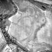 Oblique aerial view centred on the cropmarks of the barrows, ring-ditches and linear cropmarks, taken from the NW.