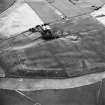 Newbarns, oblique aerial view, taken from the NE, centred on cropmarks including those of two rectilinear enclosures and several ring-ditches.