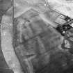 Newbarns, oblique aerial view, taken from the NNW, centred on cropmarks including those of two rectilinear enclosures and several ring-ditches.