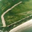 Oblique aerial view centred on the cropmarks of the unenclosed settlement, enclosures, possible souterrains and linear cropmarks, taken from the E.