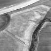 Oblique aerial view centred on the cropmarks of the unenclosed settlement and linear cropmarks, taken from the WNW.