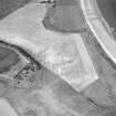 Oblique aerial view centred on the cropmarks of the unenclosed settlement and linear cropmarks, taken from the S.