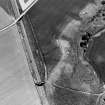 Oblique aerial view centred on the cropmarks of the ring-ditch, taken from the NNE.