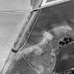 Oblique aerial view centred on the cropmarks of the ring-ditch, taken from the NNW.