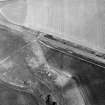 Oblique aerial view centred on the cropmarks of the ring-ditch, taken from the WSW.