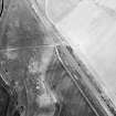 Oblique aerial view centred on the cropmarks of the ring-ditch, taken from the SW.