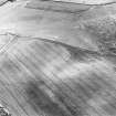 Oblique aerial view centred on the cropmarks of an unenclosed settlement, enclosures and possible souterrains, taken from the NNE.