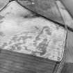 Oblique aerial view centred on the cropmarks of the unenclosed settlements, pit-alignment, pits and rig, taken from the NE.