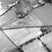 Oblique aerial view centred on the cropmarks of the rectilinear enclosure, rig and the site of the chapel, taken from the NNE.
