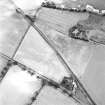 Oblique aerial view centred on the cropmarks of the rectilinear enclosure, rig and the site of the chapel, taken from the NW.