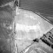 Balwyllo, oblique aerial view, taken from the WNW, centred on the cropmarks of an unenclosed settlement, an enclosure and rig.