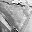 Gilrivie, oblique aerial view, taken from the SE, centred on the cropmarks of a possible unenclosed settlement, souterrains, pits, a pit-alignment and linear cropmarks.