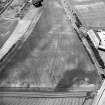 Gilrivie, oblique aerial view, taken from the ENE, centred on the cropmarks of a possible unenclosed settlement, souterrains, pits, a pit-alignment and linear cropmarks.