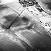 Newbigging, oblique aerial view, taken from the WNW, centred on the cropmarks of an unenclosed settlement.