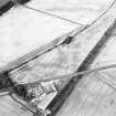 Oblique aerial view centred on the cropmarks of the enclosure, pits, rig and ring-ditch, with the farmhouse and farmsteading adjacent, taken from the SW.