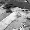 Oblique aerial view centred on the cropmarks of the cursus, enclosure, rig, barrows, and ring-ditch, taken from the ESE.