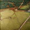 Oblique aerial view centred on the remains of the stone circle, ring cairn and field system, taken from the S.