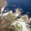 Oblique aerial view centred on the remains of the fish traps with the lazy-beds adjacent, taken from the E.