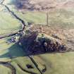 Oblique aerial view centred on the remains of the fort with the farmstead adjacent, taken from the NW.