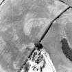 Oblique aerial view of Dowan's Hill centred on the cropmarks of a possible fort and rig with the remains of a fort adjacent, taken from the ESE.