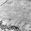 Oblique aerial view of Edentaggart centred on the remains of a farmstead, corn-drying kiln and head-dyke, taken from the NW.