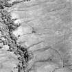 Oblique aerial view of Edentaggart centred on the remains of a farmstead, corn-drying kiln and head-dyke, taken from the WNW.