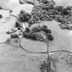Oblique aerial view of Shemore centred on the remains of the dun and a farmsteading, farmhouse and outbuildings, taken from the NNW.