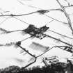 Oblique aerial view centred on the farmsteading with rig adjacent, taken from the NNW