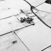 Oblique aerial view centred on the farmsteading with rig adjacent, taken from the ENE