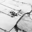 Oblique aerial view centred on the farmsteading with rig adjacent, taken from the NNE