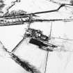 Oblique aerial view centred on the farmsteading with rig adjacent, taken from the ENE.