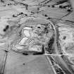 Oblique aerial view of Loudoun Hill, taken from the SE, centred on Loudounhill Sand Quarry, once the site of a Roman fort.