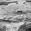 Oblique aerial view of Loudoun Hill, taken from the NE, centred on Loudounhill Sand Quarry, once the site of a Roman fort.