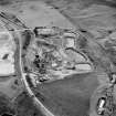 Oblique aerial view of Loudoun Hill, taken from the NW, centred on Loudounhill Sand Quarry, once the site of a Roman fort.